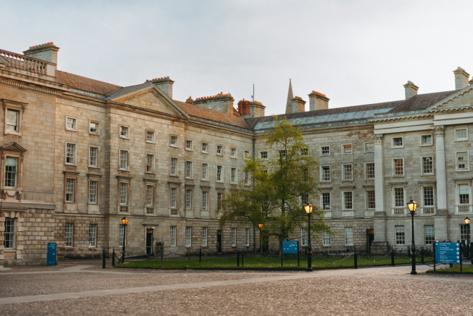 Historic university buildings surrounding a courtyard in Dublin.
